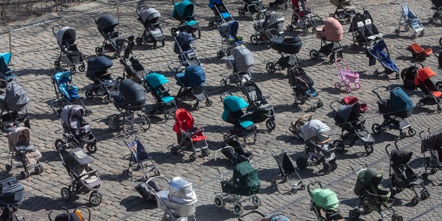 Empty strollers were placed in neat rows at the central square in Lviv, Ukraine, March 17, to symbolize children killed in the ongoing war.