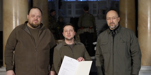 Ukraine President Volodymyr Zelenskyy signs application for the membership of Ukraine in the European Union on Monday Feb 28, 2022 in this photo released by Parliament of Ukraine. 