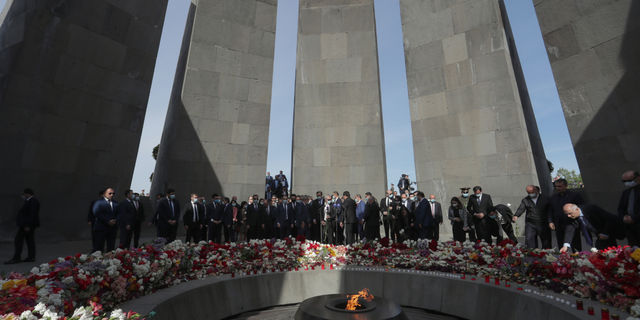 People lay flowers at the Armenian Genocide Memorial Complex on Tsitsernakaberd Hill on Armenian Genocide Remembrance Day, which commemorates to commemorate the victims of the Armenian Genocide in the Ottoman Empire.
