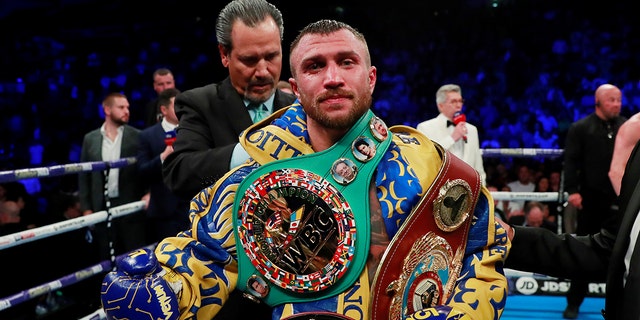 Vasyl Lomachenko poses as he celebrates winning the fight.