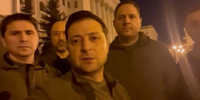 Ukrainian President Volodymyr Zelenskyy stands alongside other government officials in a video posted to social media Friday vowing to defend the country from a Russian invasion. 