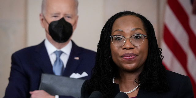 U.S. President Joe Biden (L) looks on as Ketanji Brown Jackson, circuit judge on the U.S. Court of Appeals for the District of Columbia Circuit, delivers brief remarks 