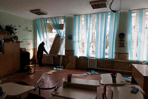 Broken windows in a classroom.