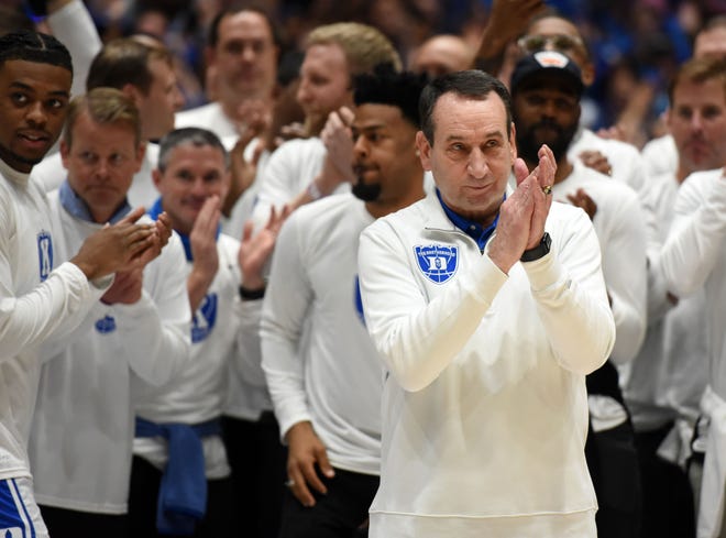 Duke coach Mike Krzyzewski (center) gestures to the crowd as they cheer prior to a game against the North Carolina Tar Heels at Cameron Indoor Stadium on March 5.