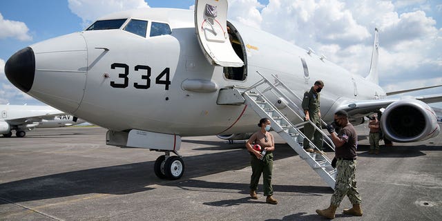 Admiral John C. Aquilino, commander of the U.S. Indo-Pacific Command (INDOPACOM), exits a U.S. P-8A Poseidon reconnaissance plane at Clark Air Base, Pampanga province, northern Philippines Sunday, March 20, 2022. 