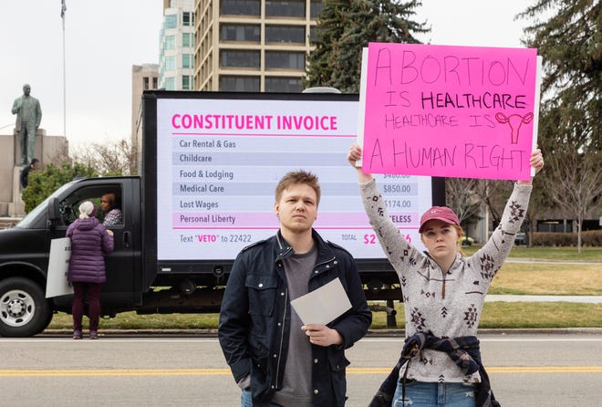 Blake Coker and Autumn Myers protest Senate Bill 1309, the Fetal Heartbeat Protection Act, during a rally at the Idaho Capitol on March, 19, 2022, in Boise, Idaho. Idaho on March 23, 2022, became the first state to enact a law modeled after a Texas statute banning abortions after about six weeks of pregnancy and allowing it to be enforced through civil lawsuits to avoid constitutional court challenges. (Sarah A. Miller/Idaho Statesman via AP, File) ORG XMIT: IDBOI302