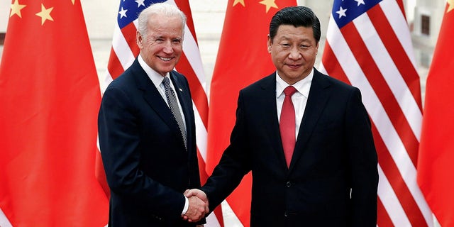 FILE PHOTO: Chinese President Xi Jinping shakes hands with U.S. Vice President Joe Biden (L) inside the Great Hall of the People in Beijing December 4, 2013. 