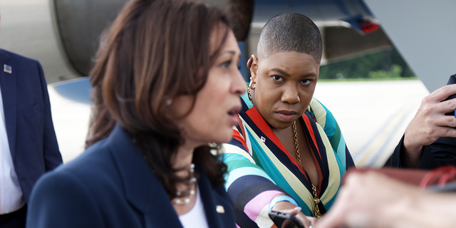 Vice President Kamala Harris speaks to members of the press as Symone D. Sanders looks on at Greenville-Spartanburg International Airport in Greer, South Carolina, before she boards Air Force Two to return to Washington June 14, 2021.