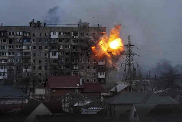 A fireball explosion on the corner of an apartment building.