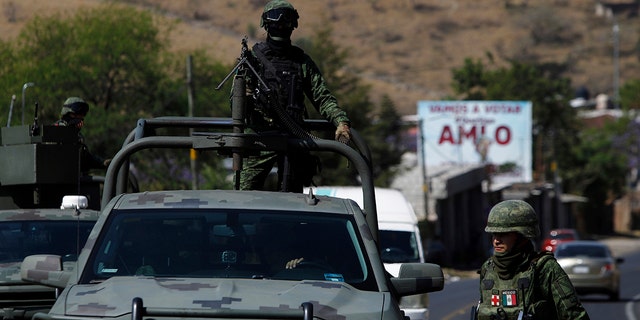 Soldiers patrol the cockfighting site "El Paraiso," or Paradise in Zinapecuaro, Mexico, on Monday. (AP Photo/Armando Solis)