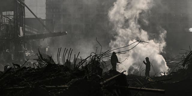 Firefighters douse the fire in the Retroville shopping mall after a Russian attack on the northwest of the capital Kyiv on March 21, 2022. 