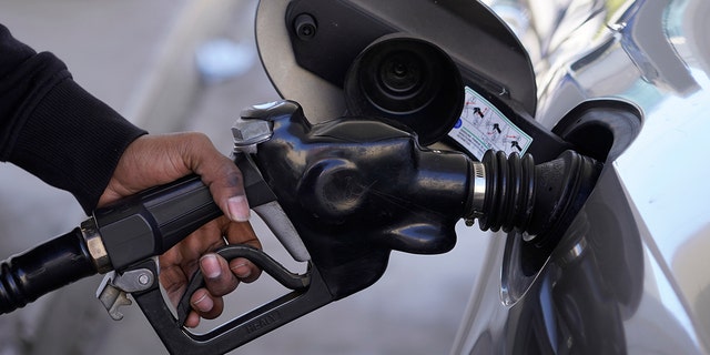 A motorist pumps gasoline at a Mobil gas station following Russia's invasion of Ukraine, in West Hollywood, Calif., Friday, Feb. 25, 2022. 