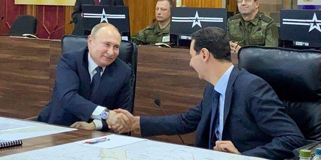 In this image released by the Syrian Presidency, Russian President Vladimir Putin, left, meets with Syrian President Bashar Assad in Damascus, Syria, on Tuesday, Jan. 7, 2020. 