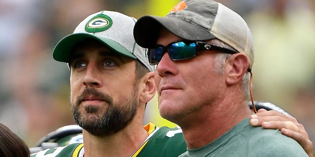 Aaron Rodgers #12 of the Green Bay Packers shares a moment with former quarterback Brett Favre during a ceremony for the late Bart Starr at halftime of the game between the Minnesota Vikings and Green Bay Packers at Lambeau Field on September 15, 2019 in Green Bay, Wisconsin.