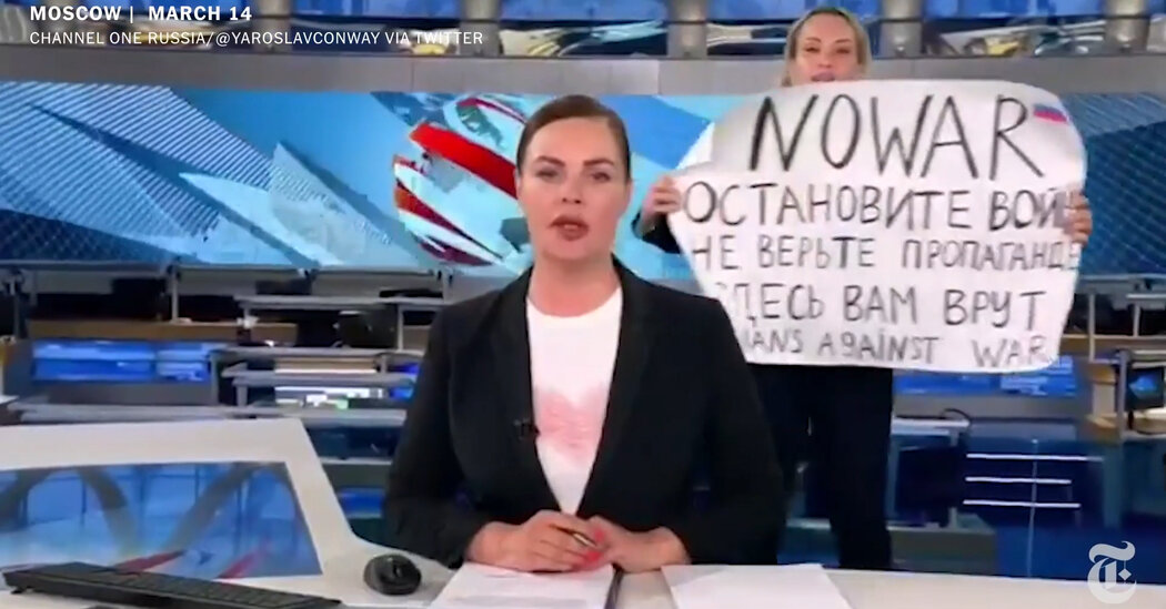 A protester storms a live broadcast on Russia’s most-watched news show, yelling ‘Stop the war!’