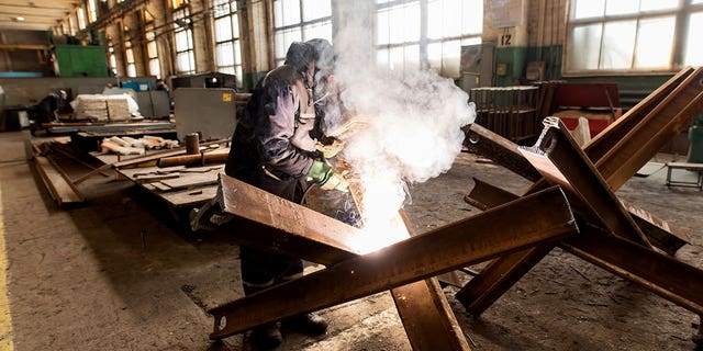 A worker welds metal inside the Interpipe Steel plant in Dnipro, Ukraine, Thursday, March 10, 2022. 