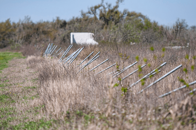 A fence damaged by Hurricane Laura.