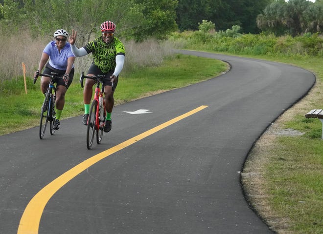Bicyclists ride through Gemini Springs Park in DeBary on Friday, April 15. The City of DeBary earned the state's Trail Town designation this month, making it the second city in Volusia County to do so.