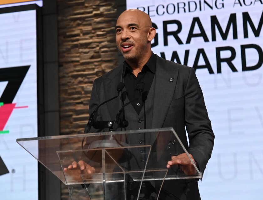 A man stands at a transparent podium.