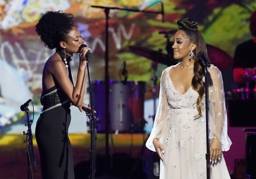 Two singers in gowns onstage