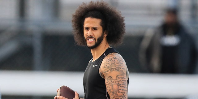 Colin Kaepernick looks to make a pass during a private NFL workout at Charles R. Drew High School Nov. 16, 2019, in Riverdale, Ga.