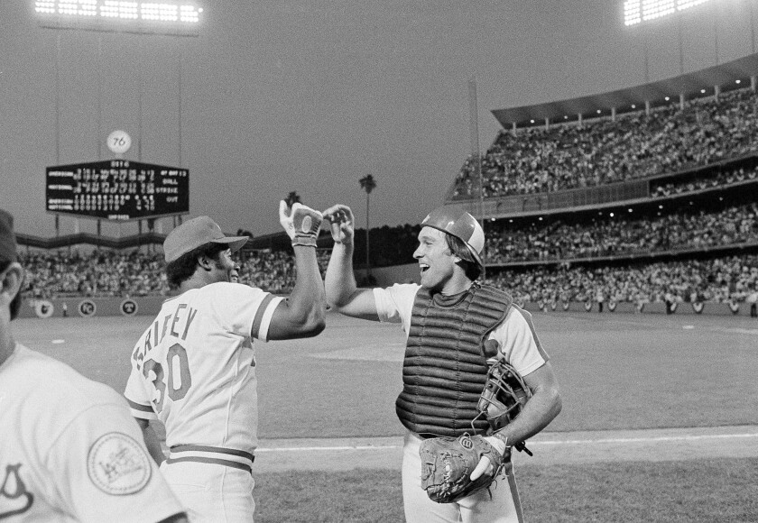 Cincinnati Reds outfielder Ken Griffey celebrates with Montreal Expos catcher Gary Carter.