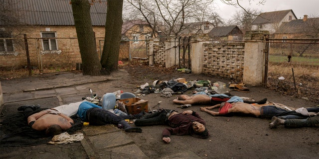 GRAPHIC CONTENT - Lifeless bodies of men, some with their hands tied behind their backs lie on the ground in Bucha, Ukraine, Sunday, April 3, 2022.