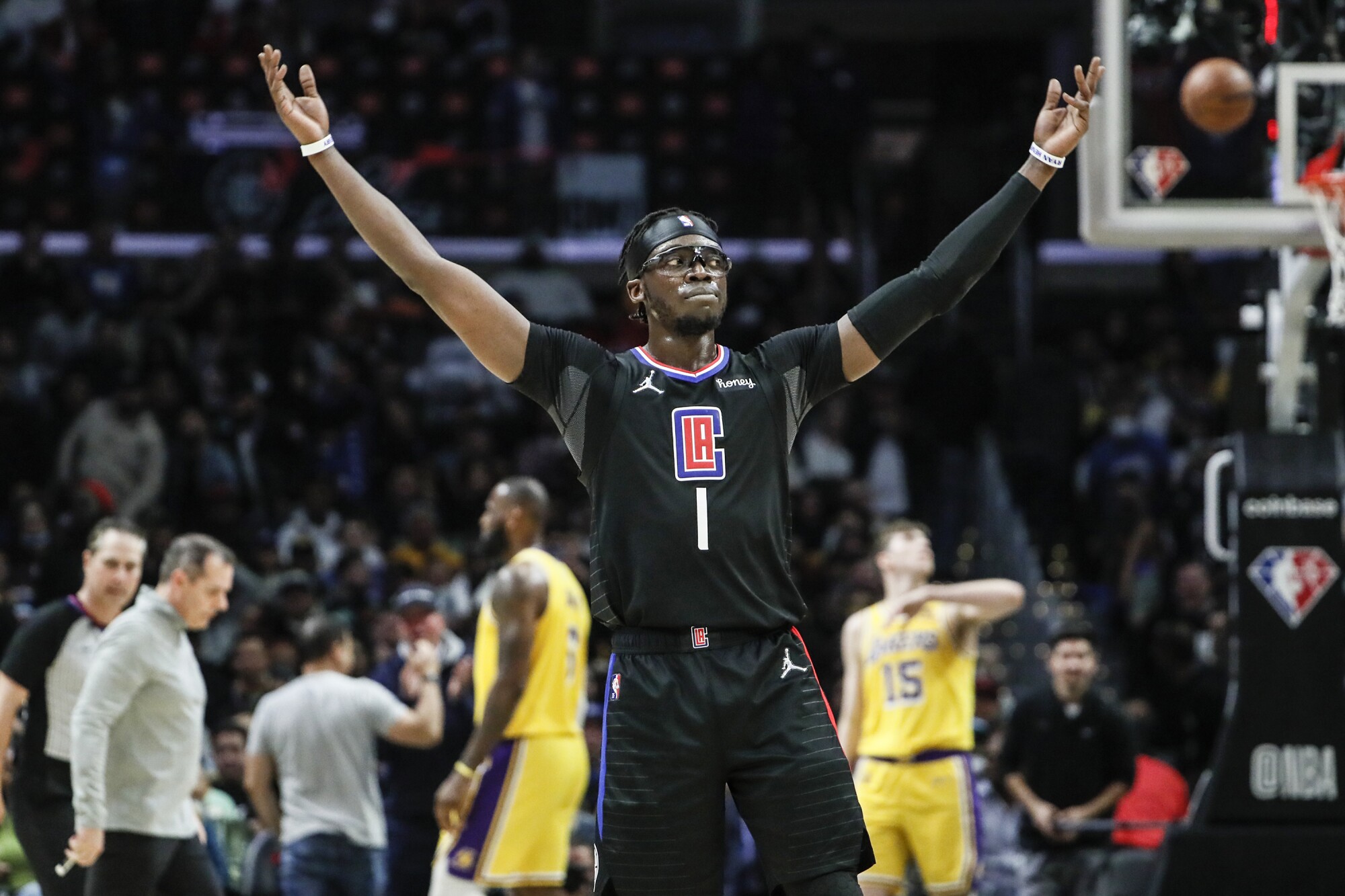 Clippers guard Reggie Jackson encourages fans to cheer as he leads the Clippers to a 132-111 win over the Lakers.