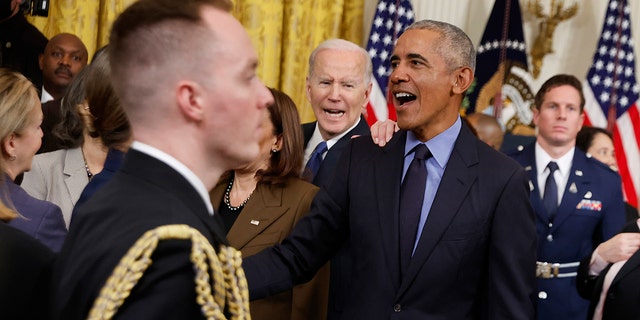 Former President Barack Obama (C) and President Joe Biden greet friends and guests at the conclusions of an event to mark the 2010 passage of the Affordable Care Act in the East Room of the White House on April 05, 2022, in Washington, D.C.