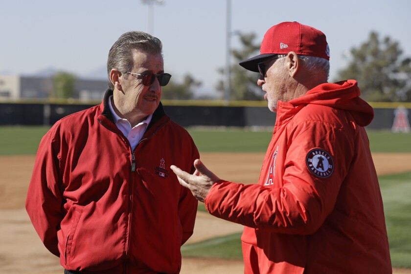 Angels manager Joe Maddon, right, talks with team owner Arte Moreno during spring training in February 2020.