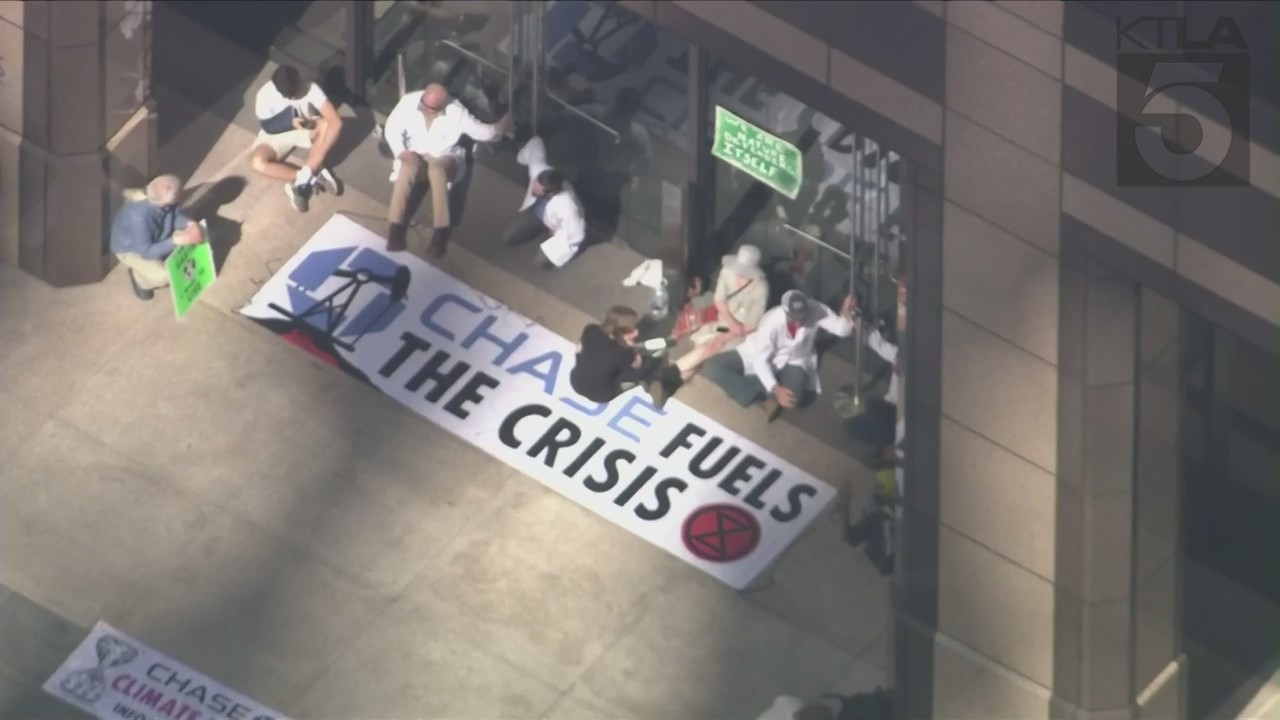 Climate activists handcuff themselves to bank building in downtown L.A.