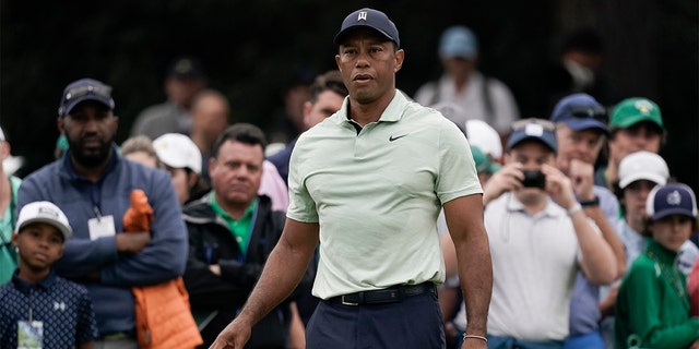 Tiger Woods drops golf balls on the driving range during a practice round for the Masters golf tournament on Tuesday, April 5, 2022, in Augusta, Ga.