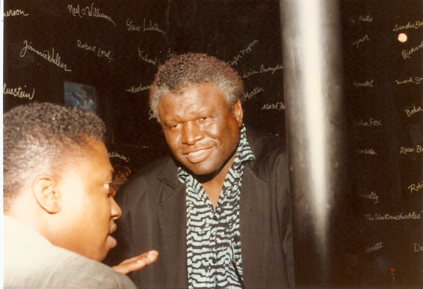 A man in a jacket and a zebra-print button-down