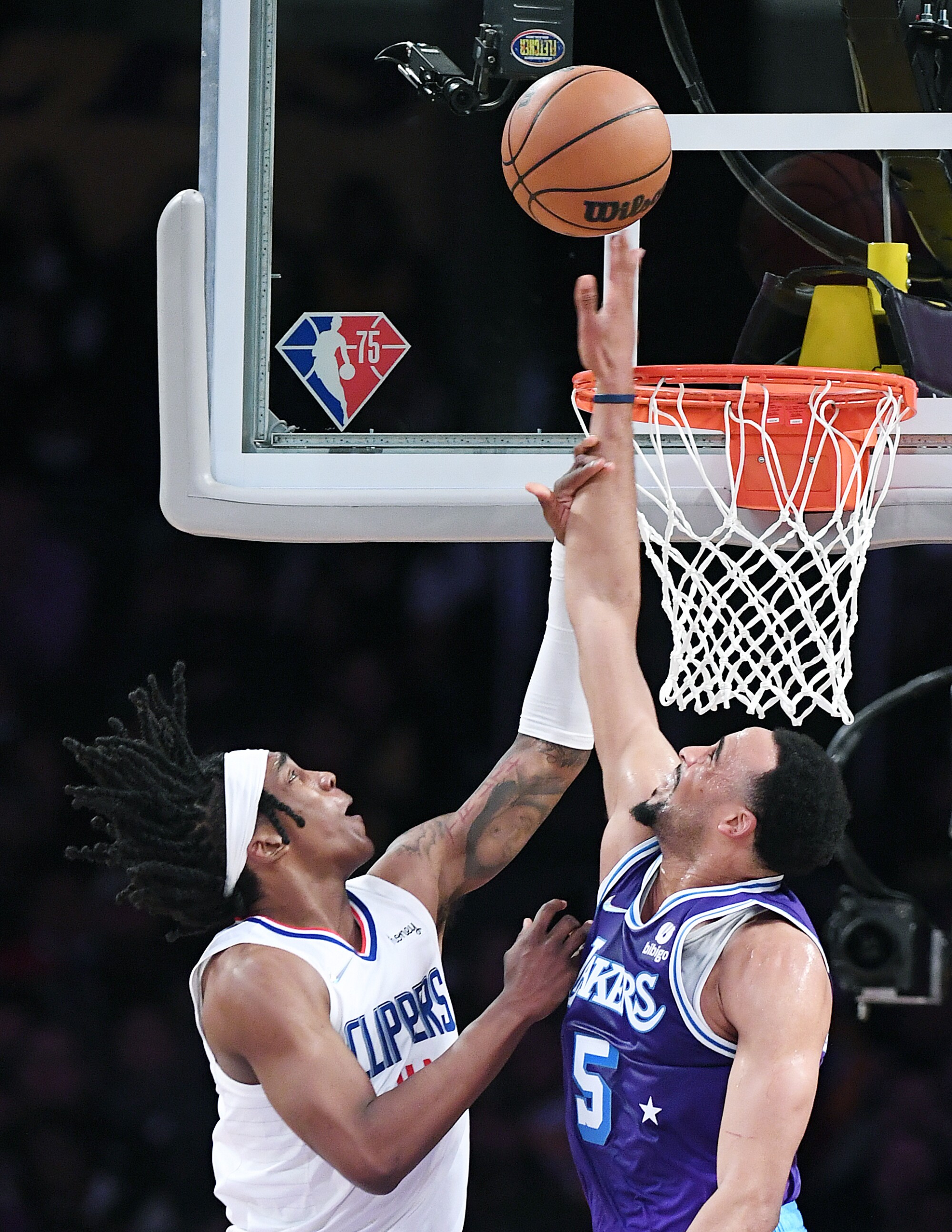 Lakers guard Talen Horton-Tucker tries to block a shot by Clippers guard Terance Mann.