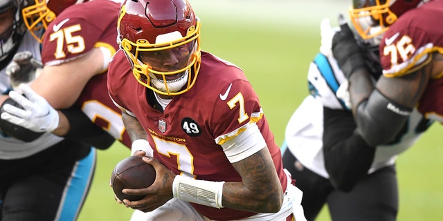 Dwayne Haskins #7 of the Washington Football Team looks to hand off the ball during a NFL football game against the Washington Football Team at FedExField on Dec. 27, 2020, in Landover, Maryland. 