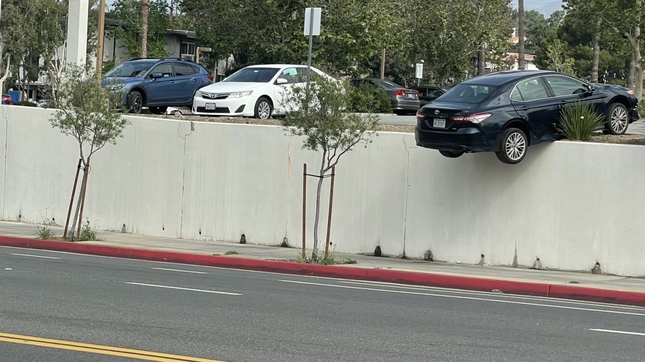 Vehicle gets stuck on retaining wall following parking mishap at Glendale department store