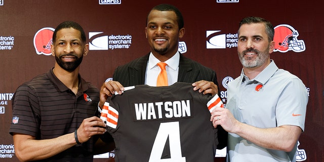 Cleveland Browns general manager Andrew Berry, left, new quarterback Deshaun Watson, center, and head coach Kevin Stefanski pose for a photo during a news conference at the team's training facility March 25, 2022, in Berea, Ohio. 