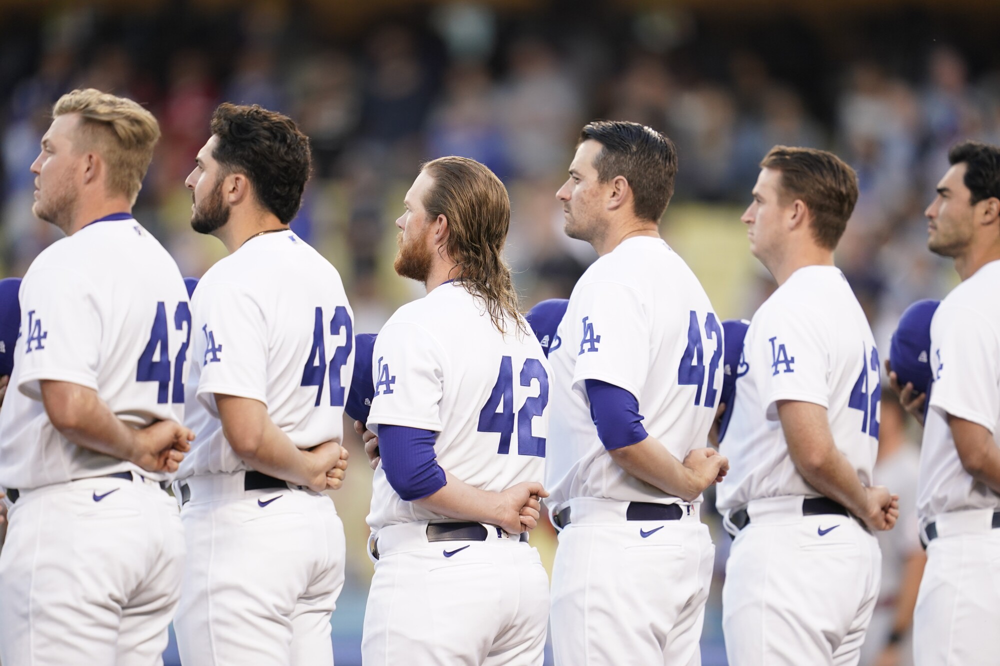 Dodgers players wear No. 42, in honor of Jackie Robinson, while listening to the singing of the national anthem.