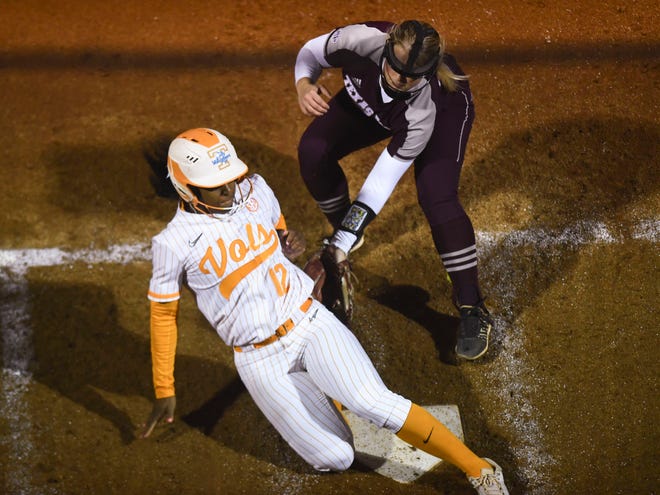 Tennessee's Lair Beautae (12) beats the tag at home plate from Texas A&M's Makinzy Herzog (24) to score in the fifth inning of the NCAA softball game in Knoxville,Tenn. on Monday, April 18, 2022. 