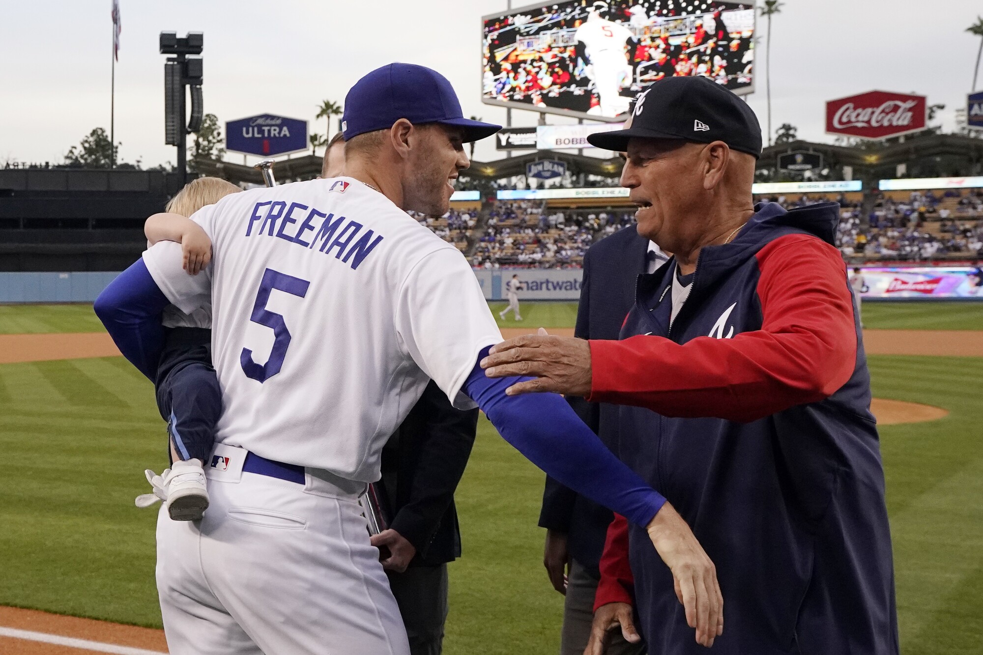 Freddie Freeman, left, hugs Atlanta Braves manager Brian Snitker before Monday's game at Dodger Stadium.