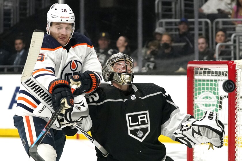 Kings goalie Jonathan Quick deflects the puck away from Edmonton Oilers forward Zach Hyman on April 7 at Crypto.com Arena.