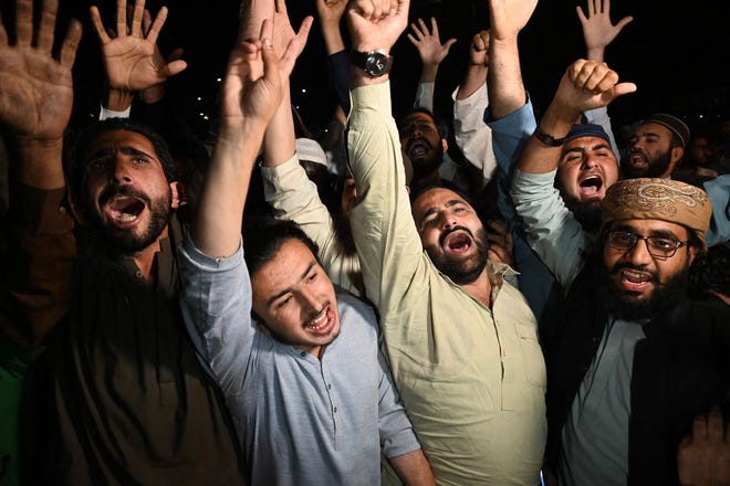 Opposition supporters chant slogans against dismissed Pakistan's prime minister Imran Khan outside the parliament house building in Islamabad on April 10, 2022.