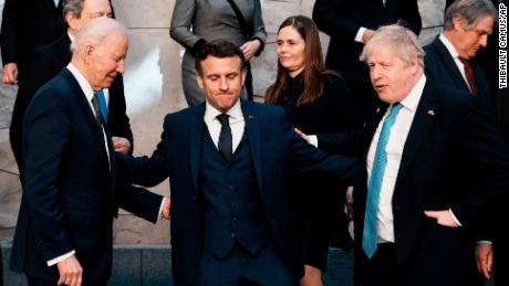 US President Joe Biden, Macron and British Prime Minister Boris Johnson speak prior to a group photo during a NATO summit in Brussels on March 24, 2022.