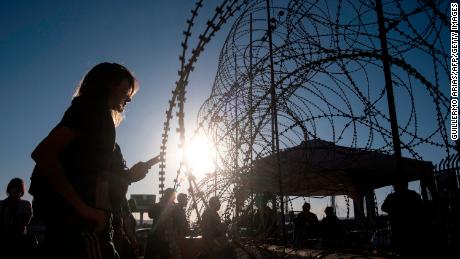 A 21-year-old asylum seeker from Ukraine waits with others from her country for US border authorities to allow them in on the Mexican side of the San Ysidro Crossing port in Tijuana, Baja California state, Mexico, on March 24, 2022.