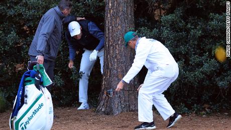 Scheffler prepares to take a drop on the 18th hole during the third round of the Masters.