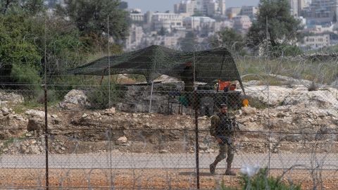 An Israeli soldier guards an opening in Israel's West Bank separation barrier on April 10.