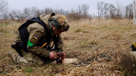 Lt. Col. Mykola Opanasenko prepares to blow up 16 unexploded Russian artillery shells.