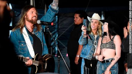 Tish Cyrus (third from right) takes a photo of Billy Ray Cyrus (left) backstage during the 2019 Stagecoach Festival at Empire Polo Field on April 28, 2019, in Indio, California.