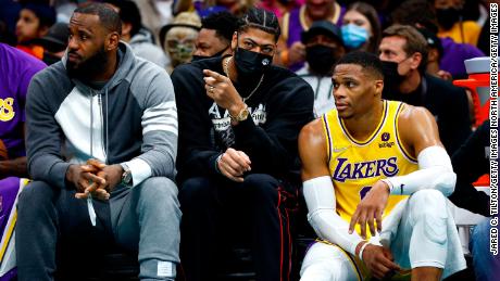 LeBron James, Anthony Davis and Russell Westbrook look on from the sidelines during the Lakers&#39; game against the Charlotte Hornets at Spectrum Center on January 28, 2022 in Charlotte.
