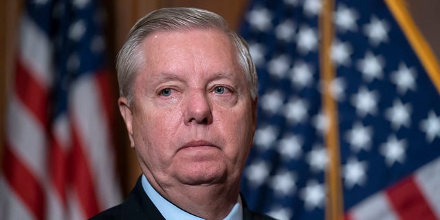 Sen. Lindsey Graham, R-S.C., the ranking member of the Senate Budget Committee, waits to speak to reporters following bipartisan passage of the Ending Forced Arbitration of Sexual Assault and Sexual Harassment Act at the Capitol in Washington, Feb. 10, 2022. 